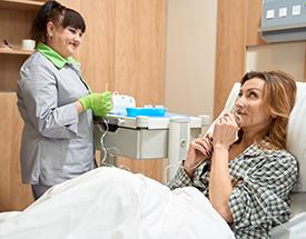 female medical worker talking to female patient